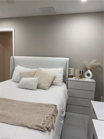 Bedroom with light tile patterned flooring