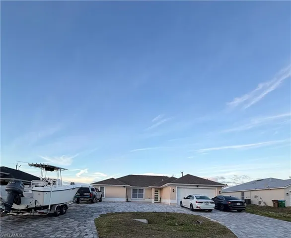 Single story home featuring decorative driveway and an attached garage