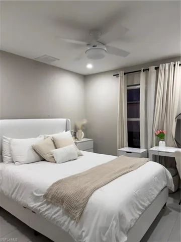Bedroom featuring light tile patterned floors and ceiling fan