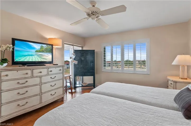 Master bedroom, wood floors, sliding door to lanai, plantation shutters, ensuite. Hurricane windows.
