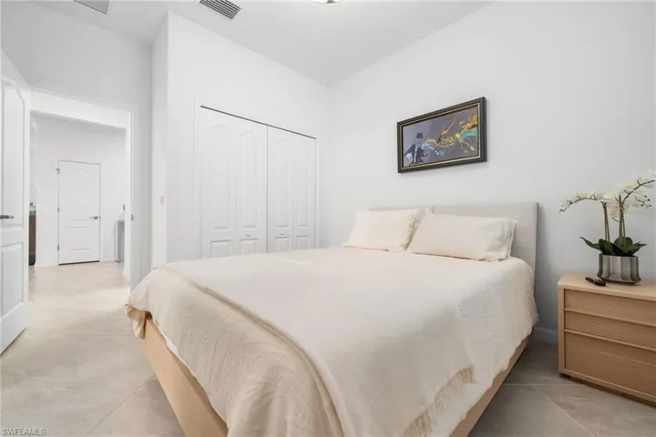 Bedroom featuring light tile patterned floors and a closet
