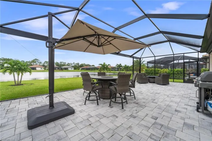 View of patio / terrace featuring glass enclosure, an outdoor living space, and a grill