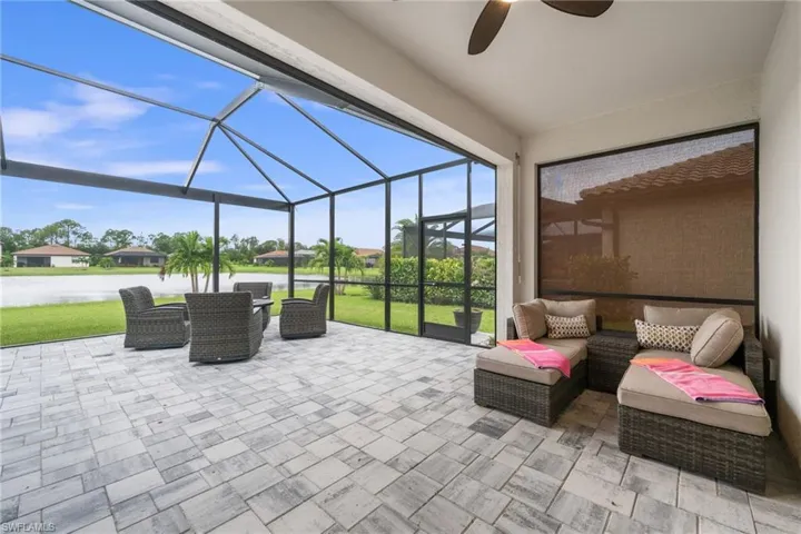 View of patio with ceiling fan, a lanai, and an outdoor hangout area