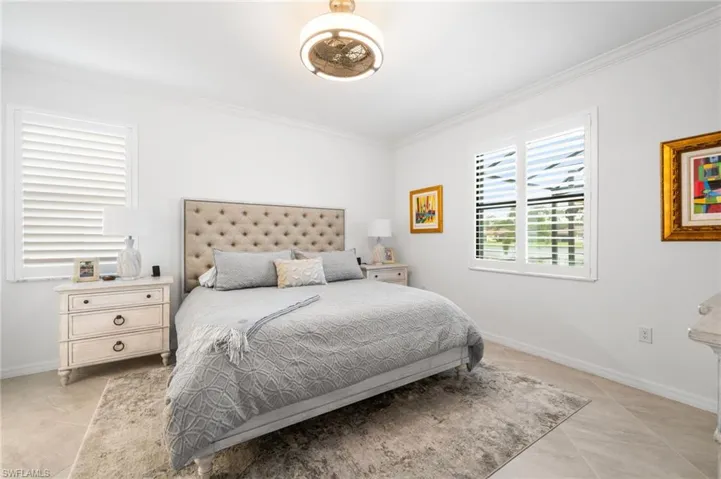 Bedroom featuring light tile patterned flooring and crown molding