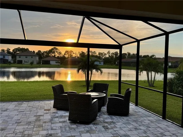 Sunroom / solarium featuring a water view