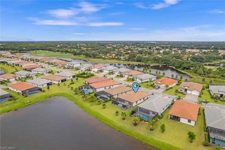 Birds eye view of property with a water view