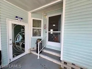 View of exterior entry featuring covered porch