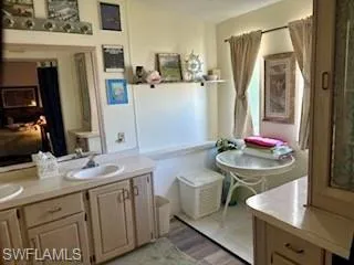 Bathroom featuring double vanity and wood-style flooring