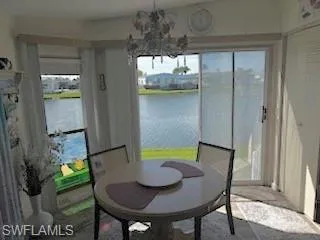 Dining area featuring a water view and a chandelier