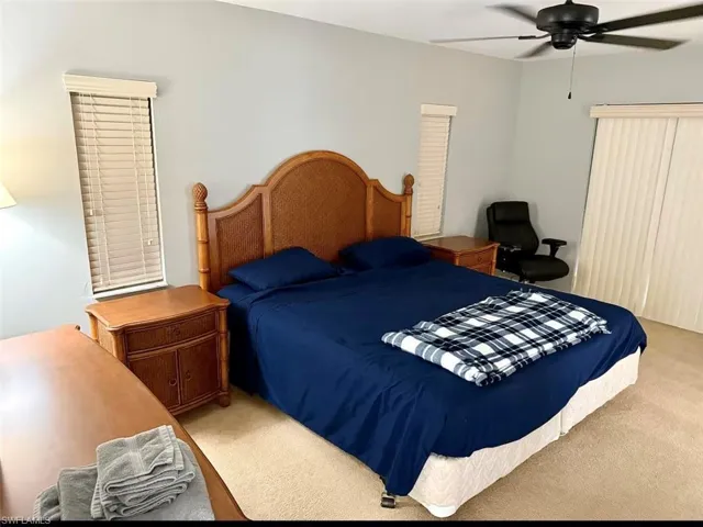 Bedroom with carpet and a ceiling fan