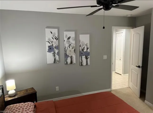 Bedroom featuring ceiling fan and carpet floors
