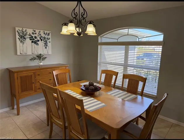 Dining room featuring light tile patterned floors and a chandelier