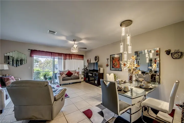 Dining space with tile patterned floors and a ceiling fan