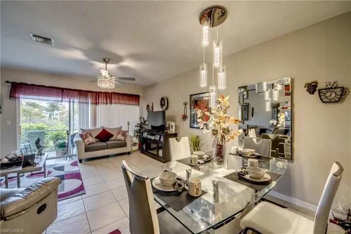 Dining space featuring light tile patterned floors and ceiling fan
