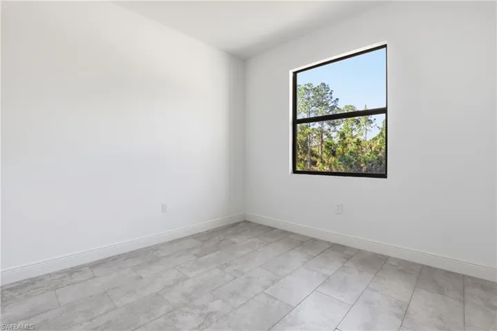 Empty room featuring baseboards