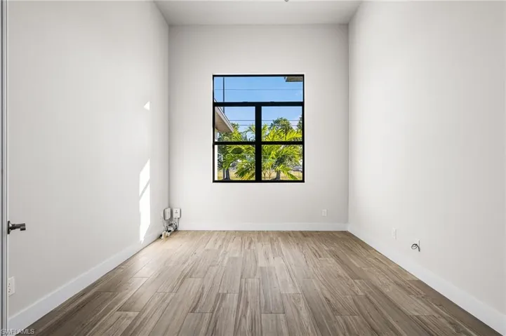 Empty room with hardwood / wood-style flooring