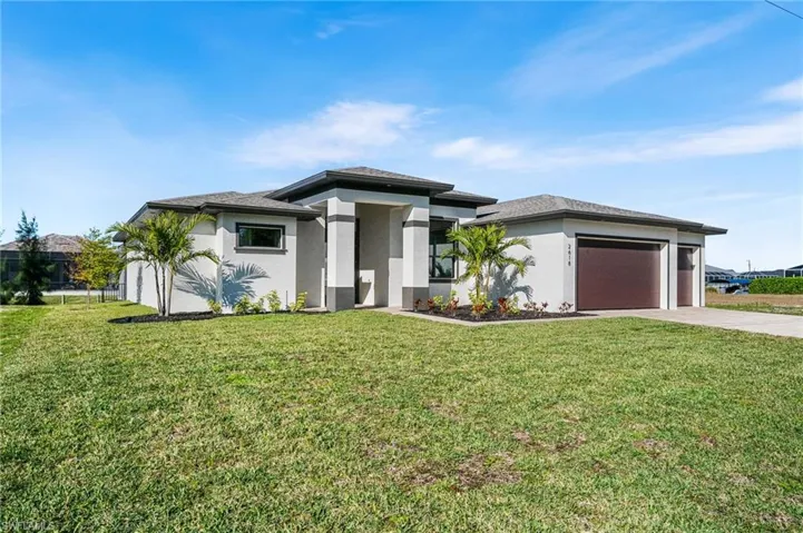 Modern-style house featuring a garage and a front yard