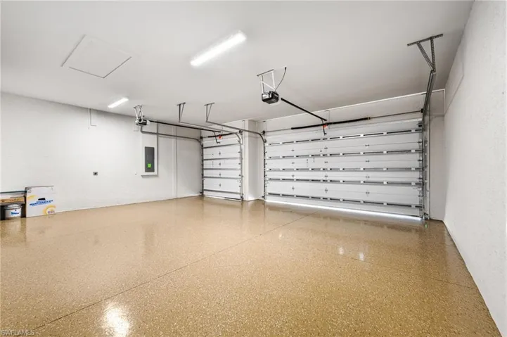Garage with electric panel and a garage door opener