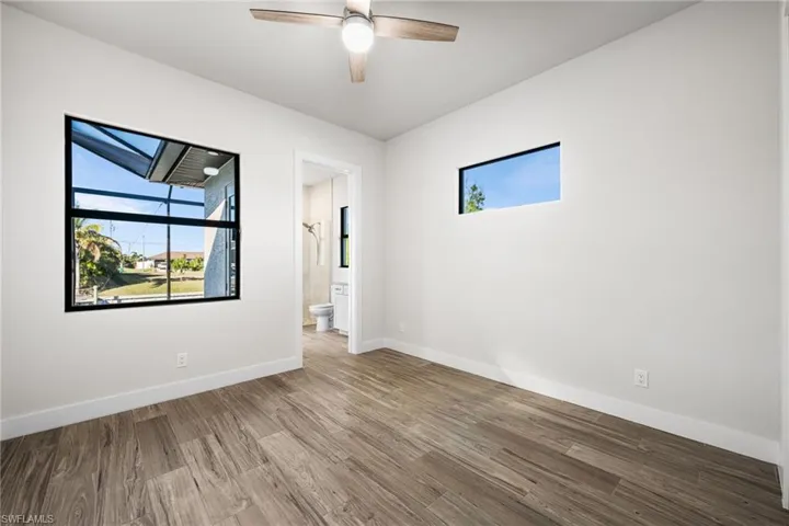 Empty room with ceiling fan and wood-type flooring