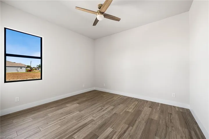 Empty room featuring wood-type flooring and ceiling fan