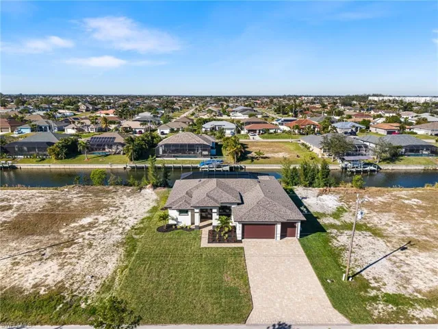 Birds eye view of property with a water view