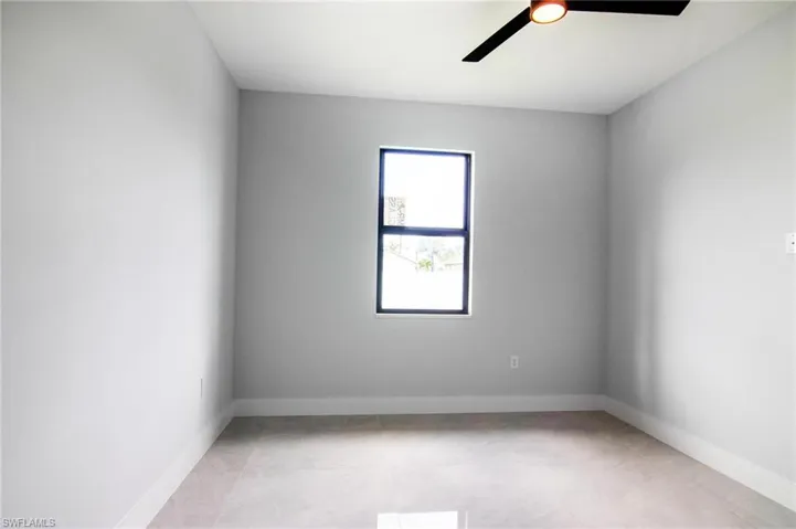 Empty room featuring ceiling fan