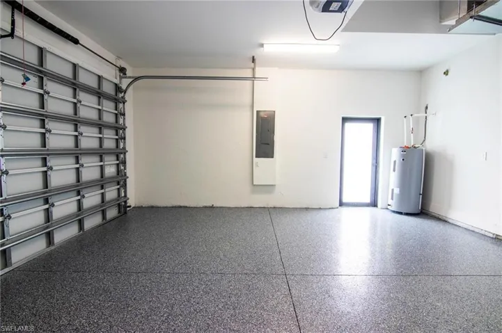 Garage with water heater and electric panel