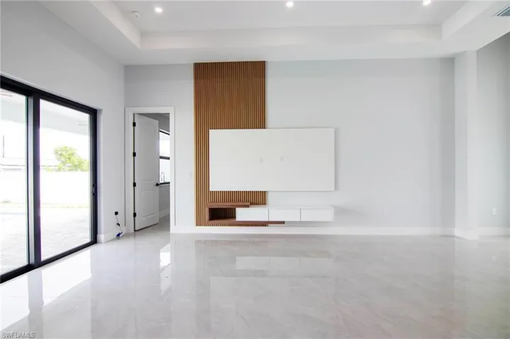 Empty room featuring a tray ceiling