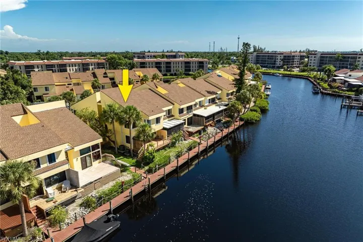 Birds eye view of property with a water view