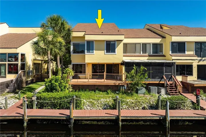 Back of property with a sunroom and a wooden deck
