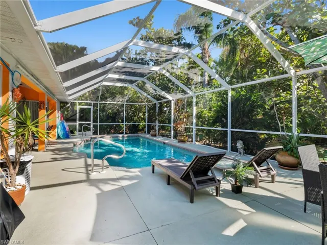 Outdoor pool featuring a patio and glass enclosure