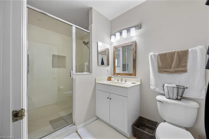 Bathroom featuring a shower stall and vanity