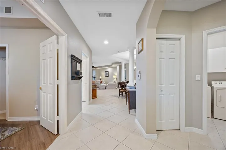 Hall featuring washer / dryer, recessed lighting, and light tile patterned flooring