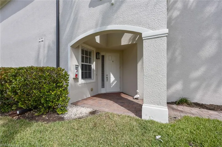 View of exterior entry featuring stucco siding