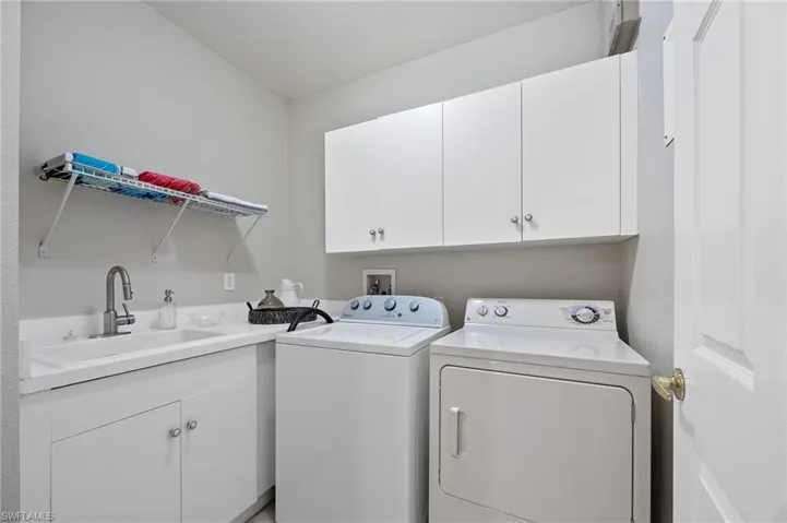 Laundry area featuring cabinet space and independent washer and dryer