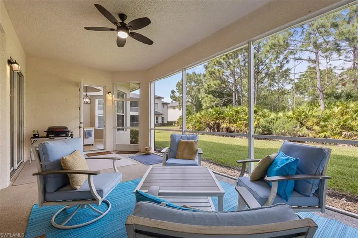 Sunroom featuring a ceiling fan and an outdoor living space