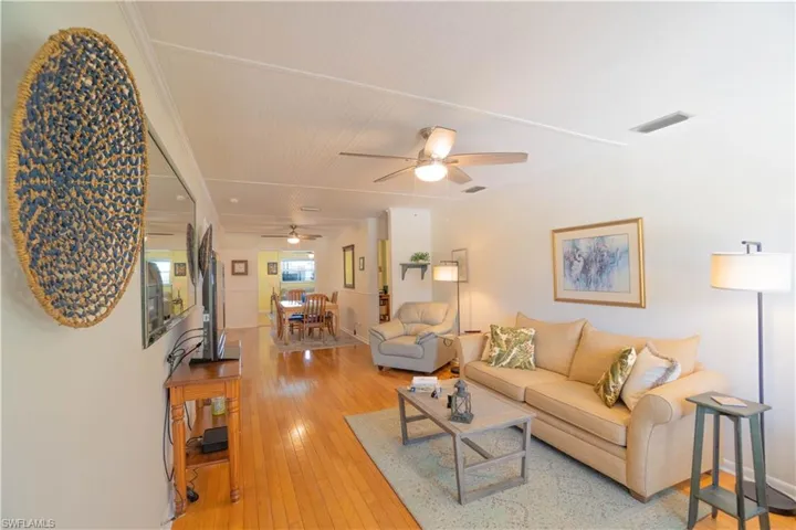 Living area featuring light wood-style flooring and ceiling fan