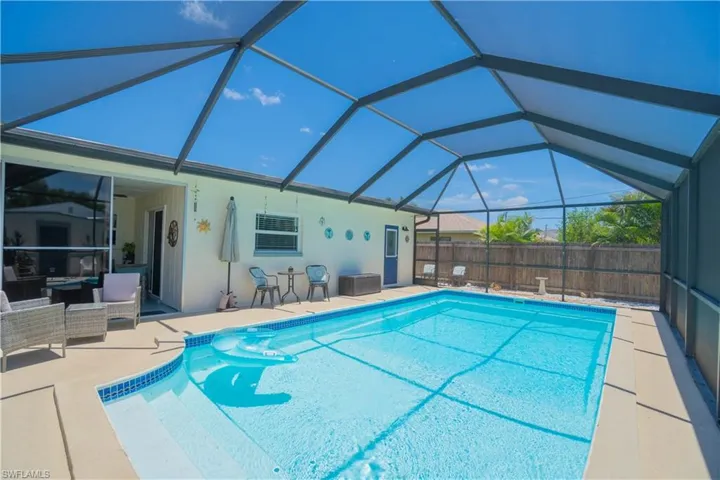 View of swimming pool with a patio, glass enclosure, a sunroom, and an outdoor hangout area