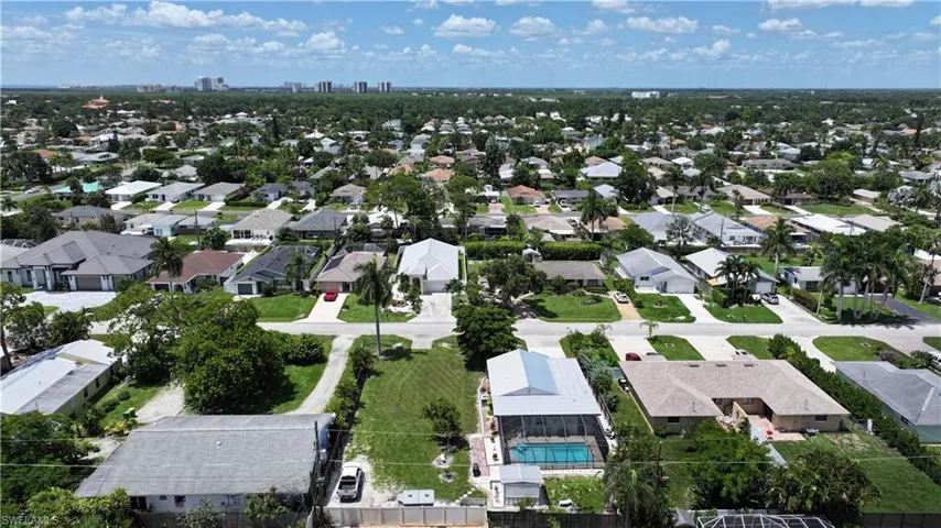 Aerial view of property's location with nearby suburban area