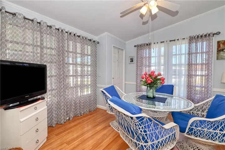 Dining area featuring ceiling fan, crown molding, and light hardwood / wood-style flooring