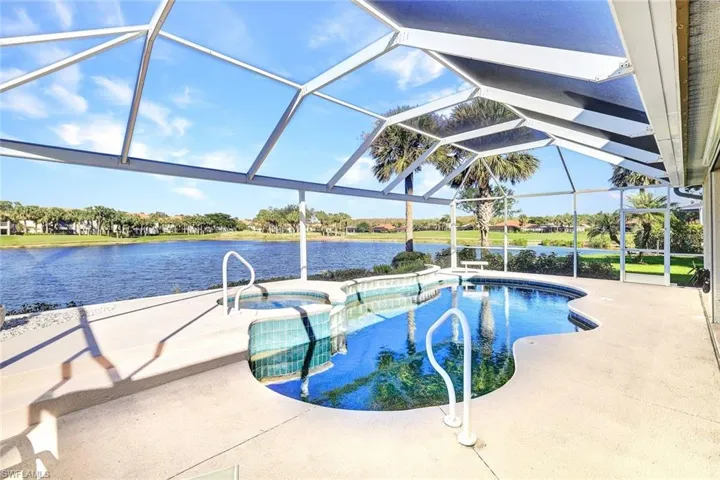 View of swimming pool with a lanai, a patio area, and a water view