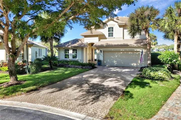View of front facade with a front yard and a garage