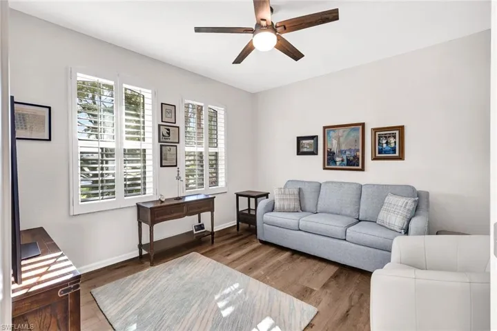 Living room with hardwood / wood-style flooring and ceiling fan