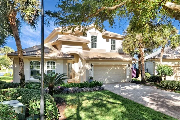 View of front of house with a garage and a front yard