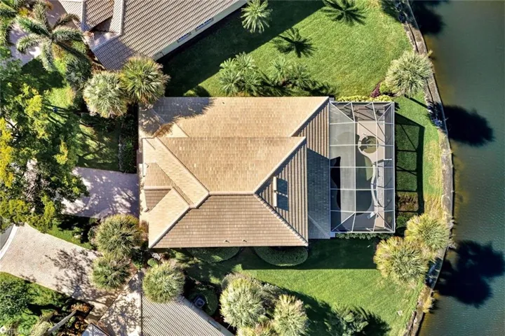 Birds eye view of property with a water view