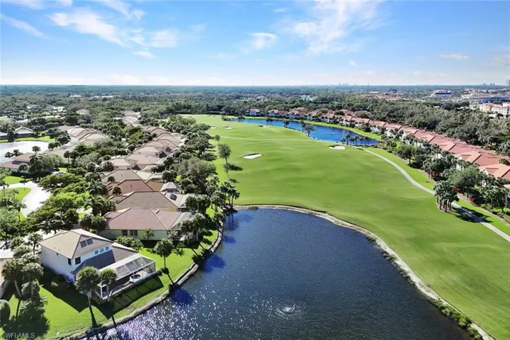 Birds eye view of property with a water view
