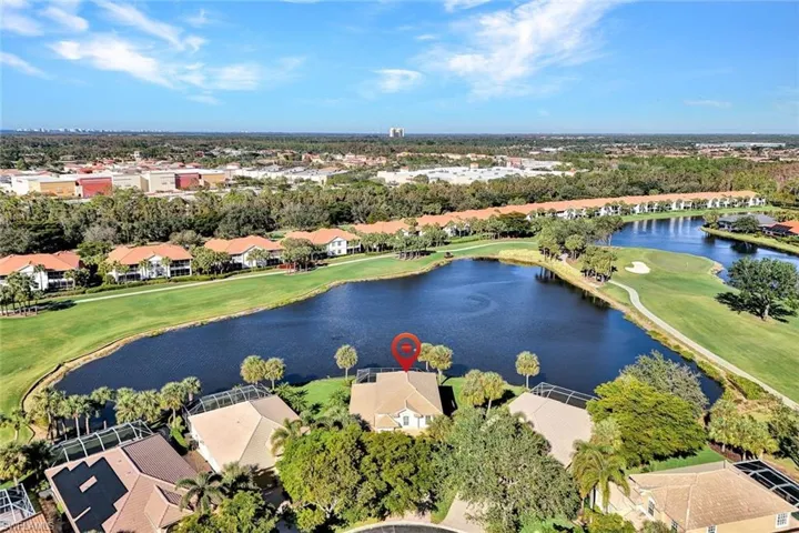 Birds eye view of property with a water view