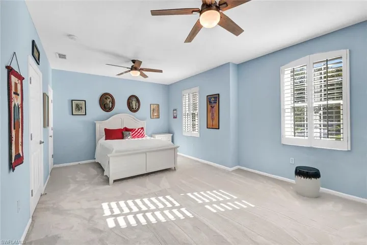 Bedroom featuring light colored carpet and ceiling fan