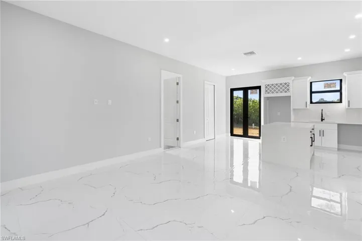 Unfurnished room with recessed lighting and light marble finish flooring