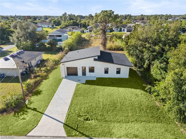 Aerial perspective of suburban area featuring a tree filled landscape